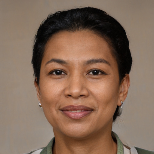 Joyful latino adult female with short  brown hair and brown eyes