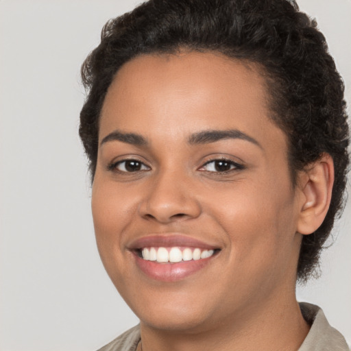 Joyful white young-adult female with short  brown hair and brown eyes