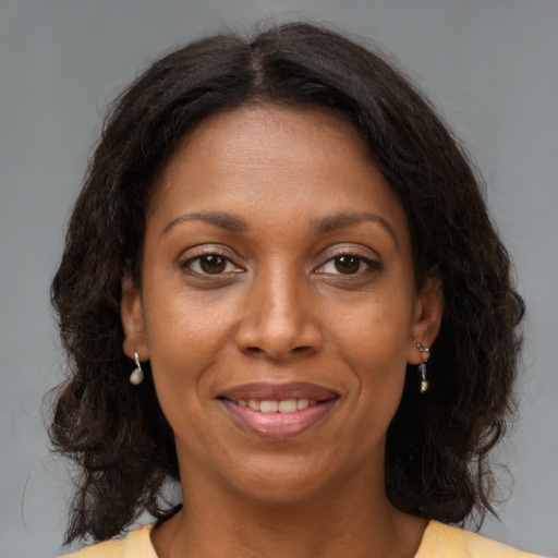 Joyful black young-adult female with medium  brown hair and brown eyes