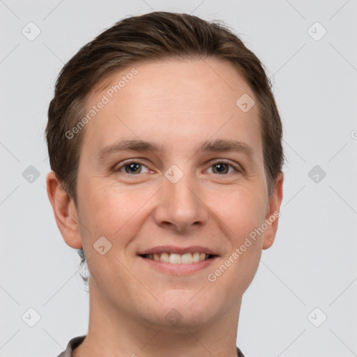 Joyful white young-adult male with short  brown hair and grey eyes