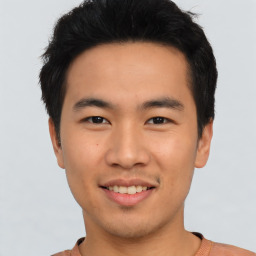 Joyful asian young-adult male with short  black hair and brown eyes