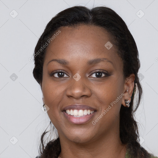 Joyful black young-adult female with long  brown hair and brown eyes