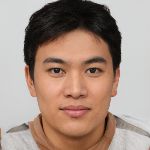 Joyful asian young-adult male with short  black hair and brown eyes