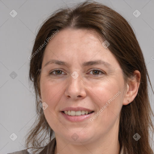 Joyful white adult female with medium  brown hair and grey eyes