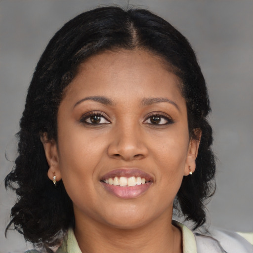 Joyful black young-adult female with medium  brown hair and brown eyes