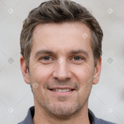 Joyful white adult male with short  brown hair and grey eyes