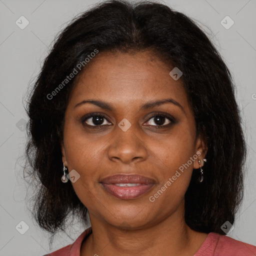 Joyful black adult female with medium  brown hair and brown eyes