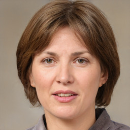 Joyful white adult female with medium  brown hair and grey eyes