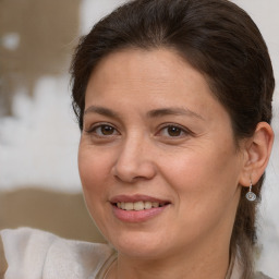 Joyful white adult female with medium  brown hair and brown eyes