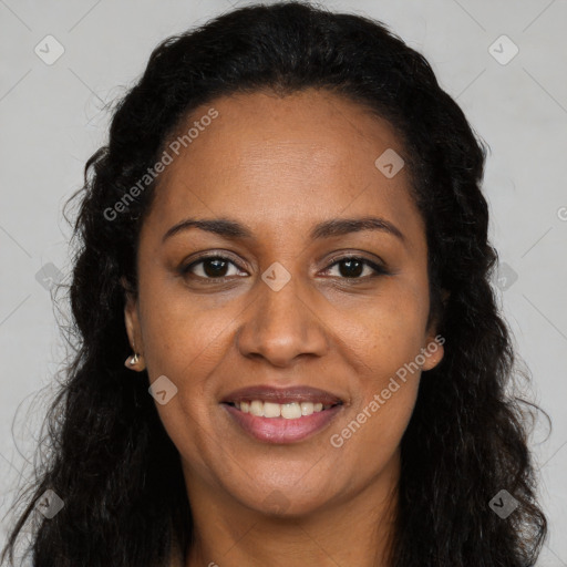 Joyful black adult female with long  brown hair and brown eyes