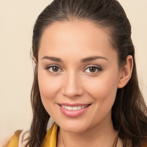 Joyful white young-adult female with long  brown hair and brown eyes