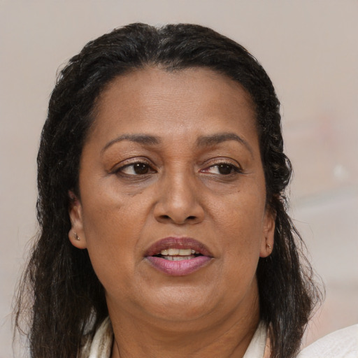 Joyful black adult female with medium  brown hair and brown eyes