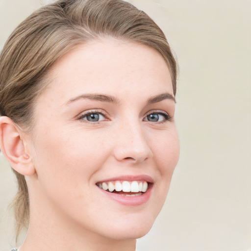 Joyful white young-adult female with medium  brown hair and blue eyes