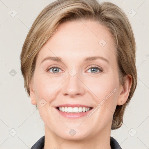 Joyful white young-adult female with medium  brown hair and blue eyes