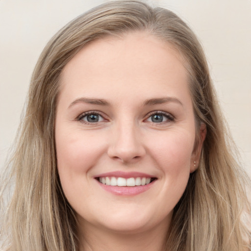 Joyful white young-adult female with long  brown hair and grey eyes