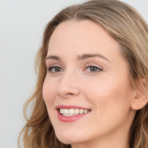 Joyful white young-adult female with long  brown hair and green eyes