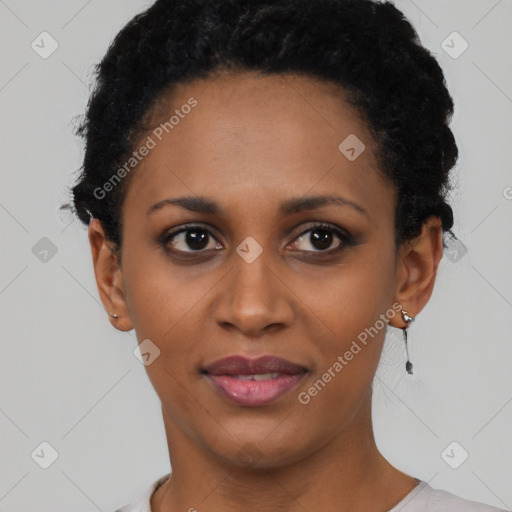 Joyful black young-adult female with short  black hair and brown eyes