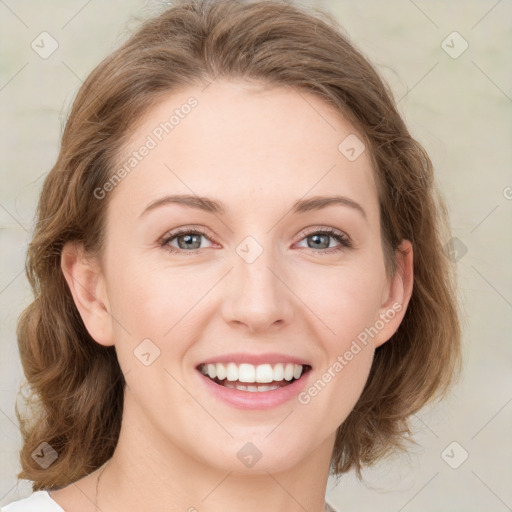 Joyful white young-adult female with medium  brown hair and green eyes