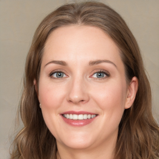 Joyful white young-adult female with long  brown hair and grey eyes