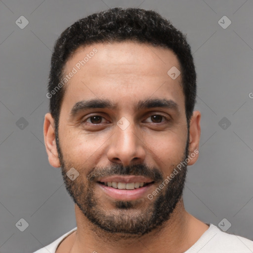 Joyful white young-adult male with short  black hair and brown eyes