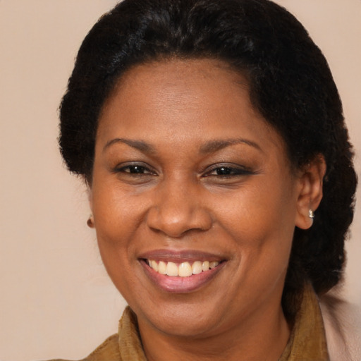 Joyful black adult female with short  brown hair and brown eyes
