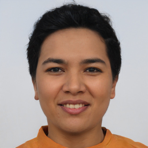 Joyful latino young-adult female with short  black hair and brown eyes