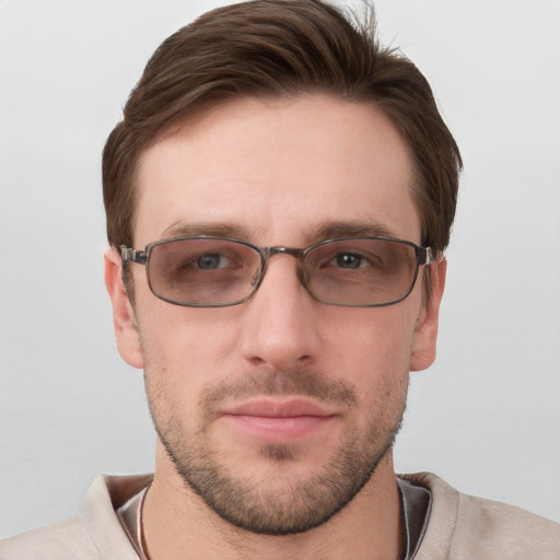 Joyful white young-adult male with short  brown hair and grey eyes