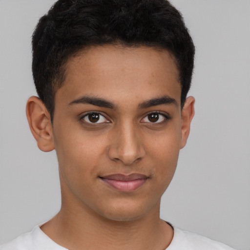 Joyful latino young-adult male with short  brown hair and brown eyes