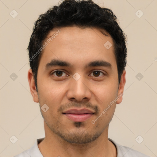 Joyful latino young-adult male with short  black hair and brown eyes