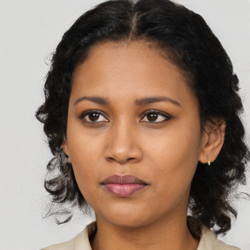 Joyful black young-adult female with medium  black hair and brown eyes