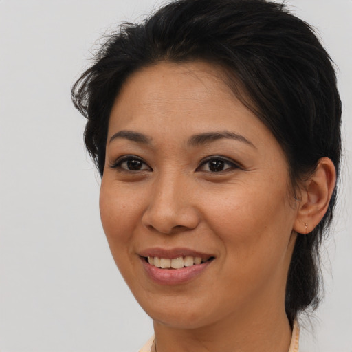 Joyful latino young-adult female with medium  brown hair and brown eyes