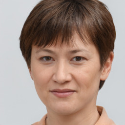 Joyful white adult female with short  brown hair and brown eyes