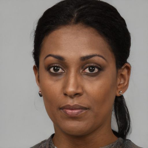Neutral black young-adult female with medium  black hair and brown eyes