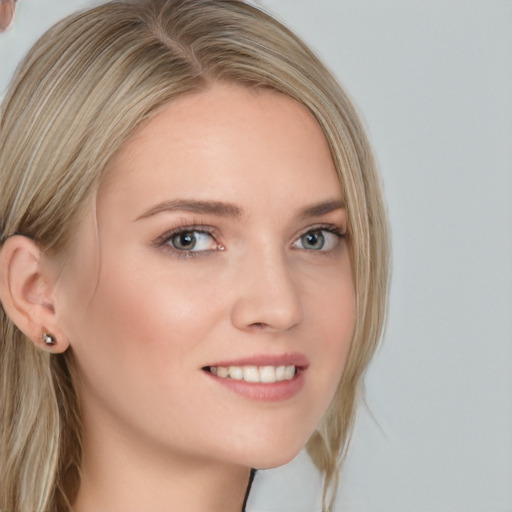 Joyful white young-adult female with medium  blond hair and grey eyes