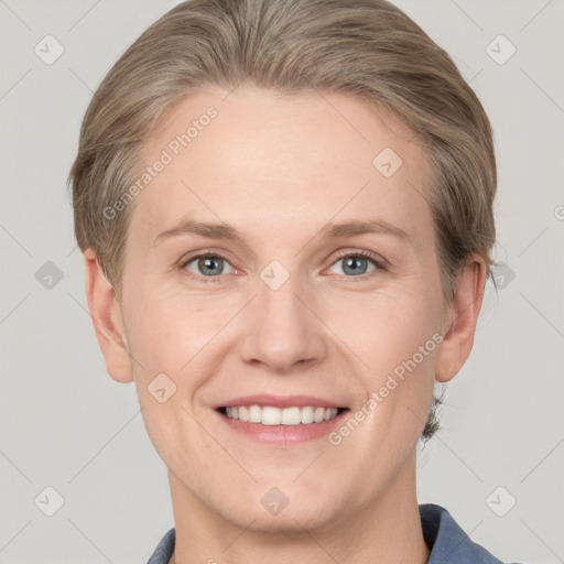 Joyful white adult female with short  brown hair and grey eyes