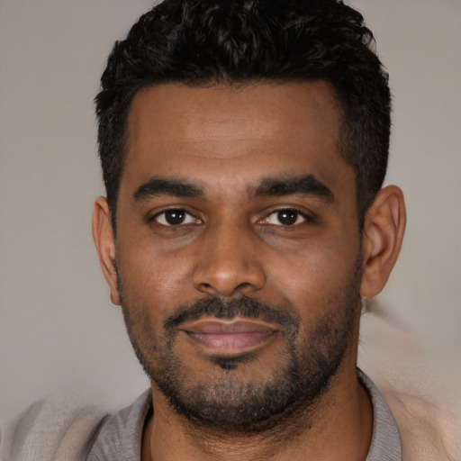 Joyful latino young-adult male with short  black hair and brown eyes