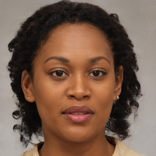 Joyful black young-adult female with medium  brown hair and brown eyes