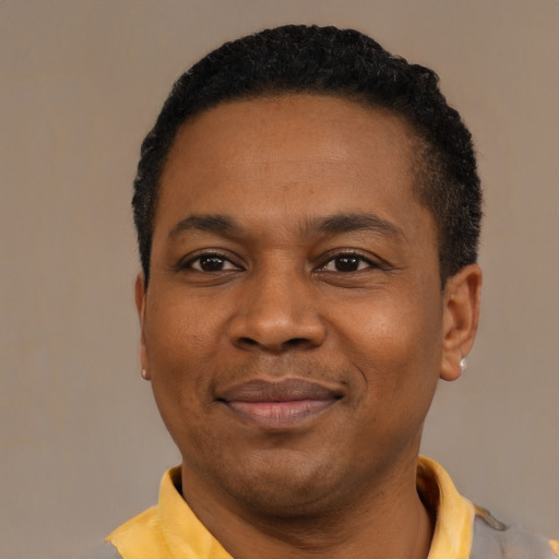 Joyful black young-adult male with short  black hair and brown eyes
