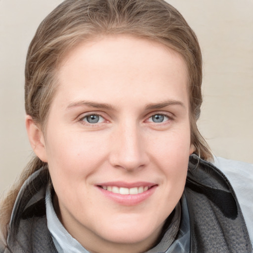 Joyful white young-adult female with medium  brown hair and blue eyes