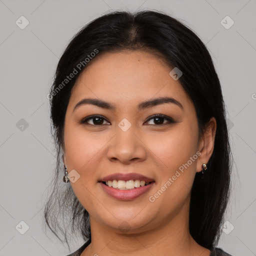 Joyful latino young-adult female with long  brown hair and brown eyes