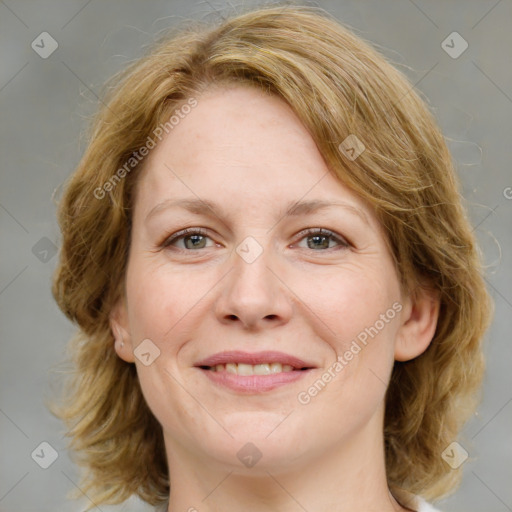 Joyful white adult female with medium  brown hair and green eyes