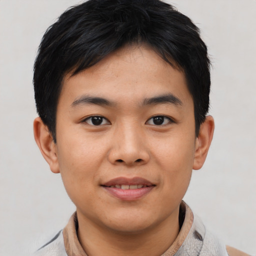 Joyful asian young-adult male with short  black hair and brown eyes