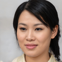 Joyful asian young-adult female with medium  black hair and brown eyes