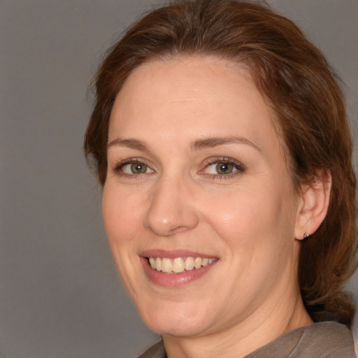 Joyful white adult female with medium  brown hair and brown eyes