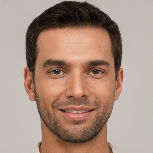 Joyful white young-adult male with short  brown hair and brown eyes