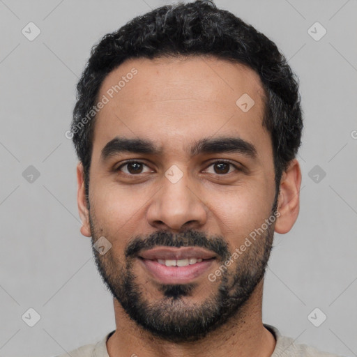 Joyful latino young-adult male with short  black hair and brown eyes