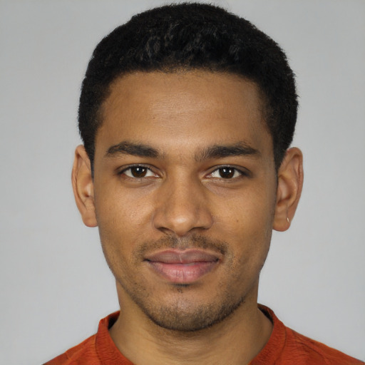 Joyful black young-adult male with short  black hair and brown eyes