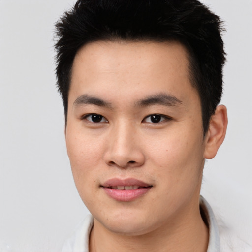 Joyful asian young-adult male with short  black hair and brown eyes