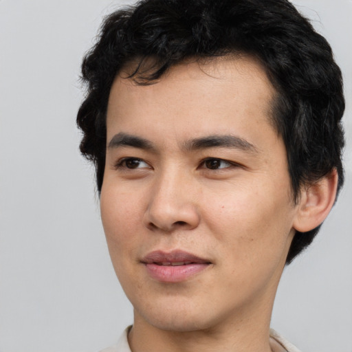Joyful asian young-adult male with short  black hair and brown eyes