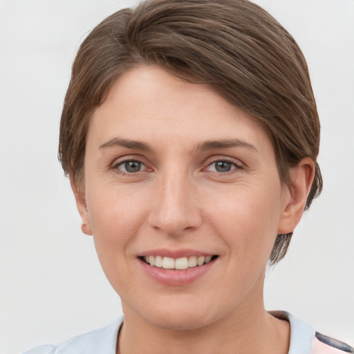 Joyful white young-adult female with short  brown hair and grey eyes